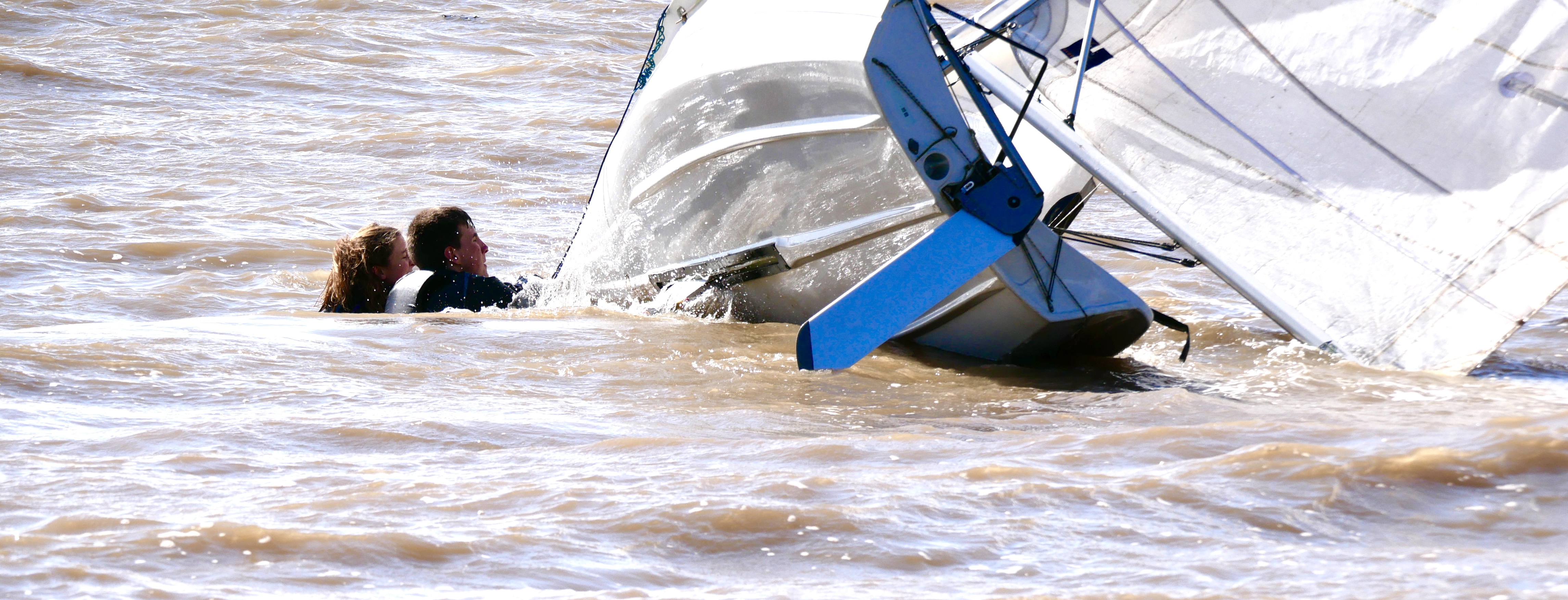 James Bishop and Noa Crowley in a bit of bother near the rocks while Lucy Leyshon sails on to her 4th overall in the series